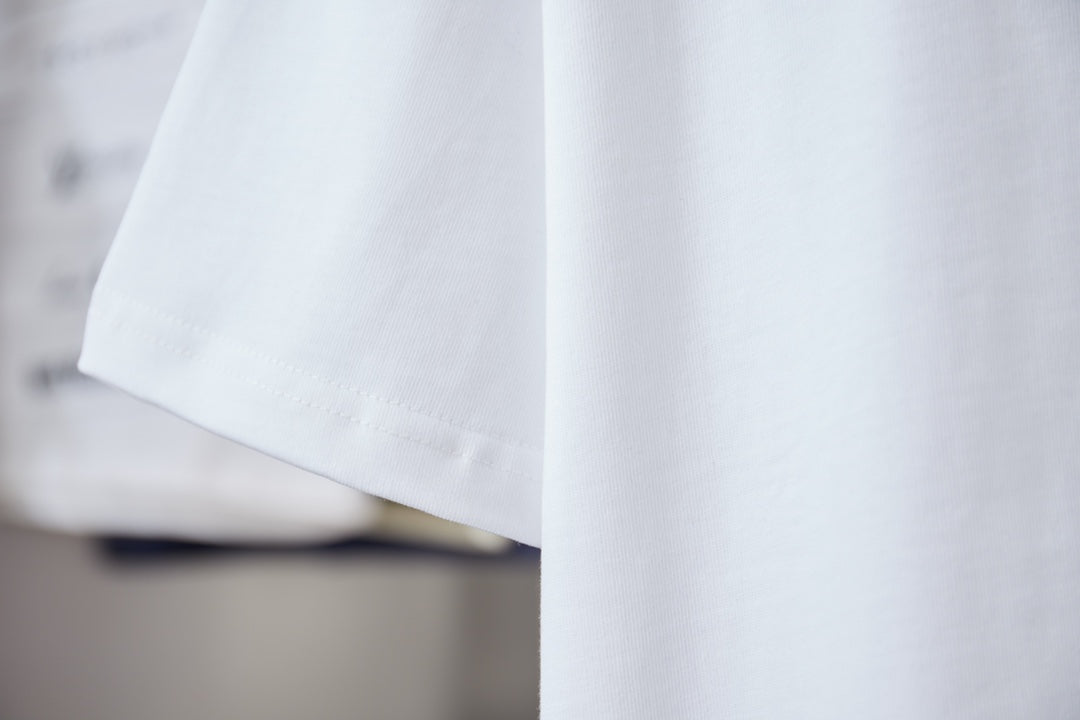White short-sleeve T-shirt sleeve and hem, embroidered detail near chest