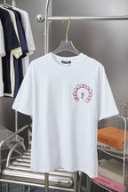 White short-sleeve T-shirt with red embroidered ring graphic and cross