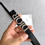Dior belt angled view, black strap with silver buckle and Dior lettering