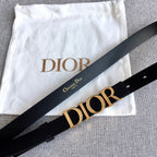 Black belt with large gold-tone Dior logo buckle and leather strap, angled view