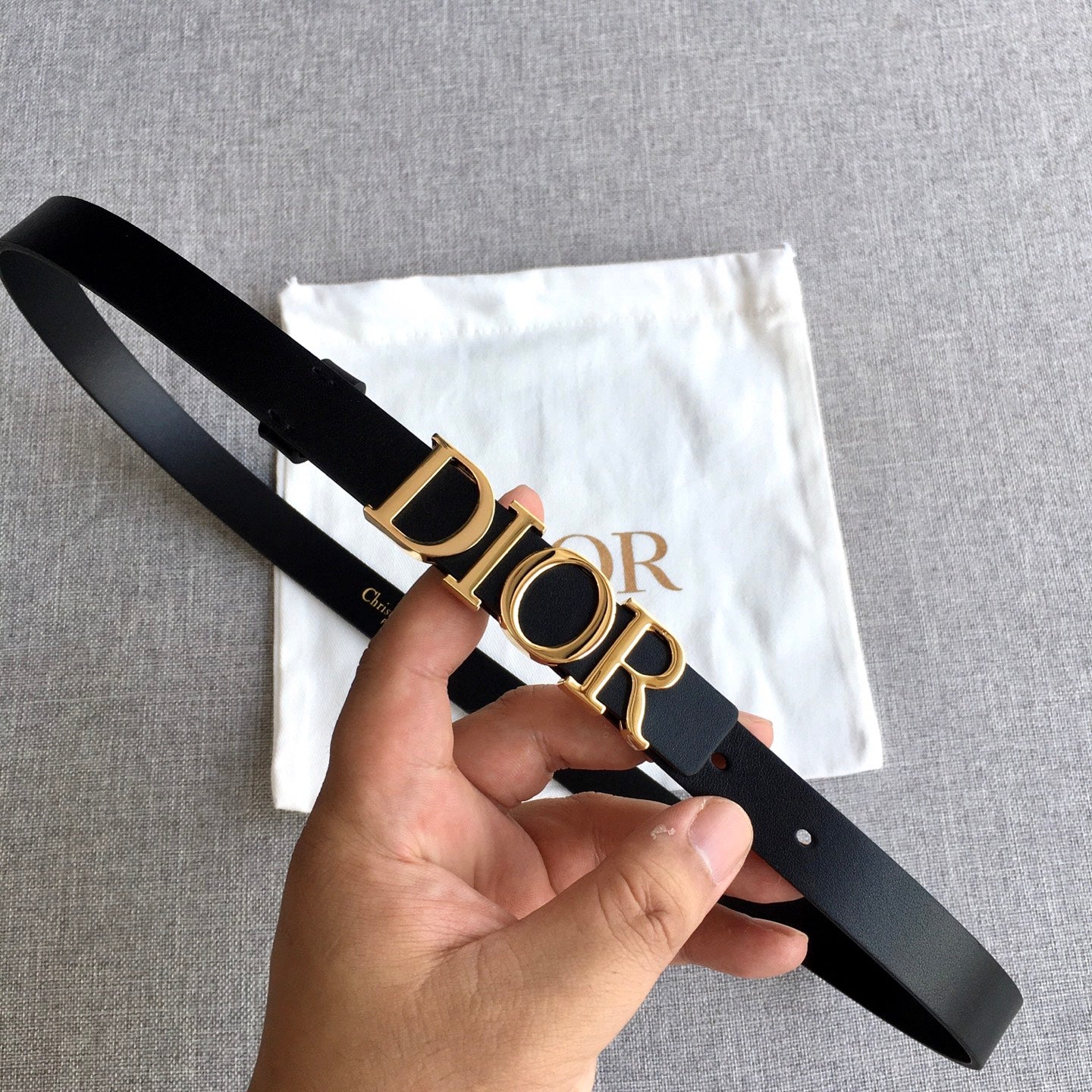 Black leather belt with gold-tone Dior buckle and adjustable holes