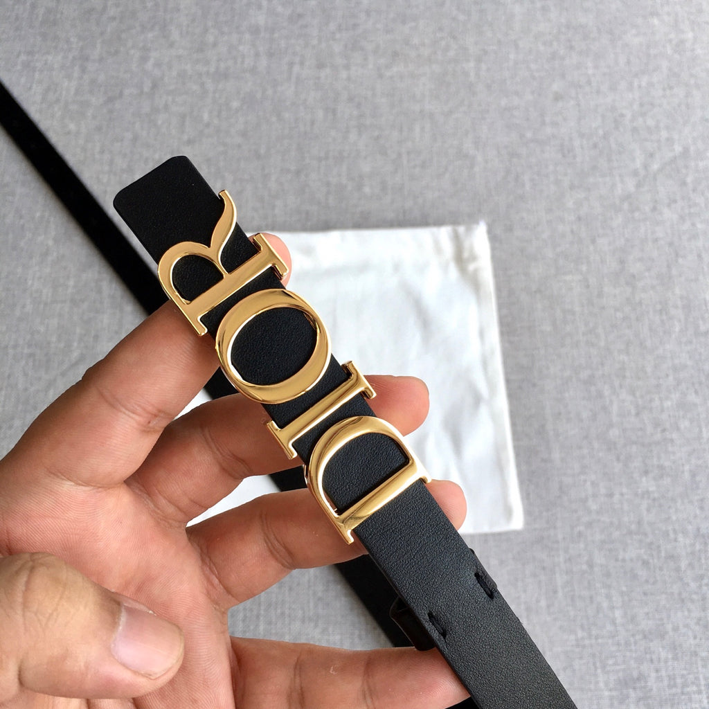 Black leather belt with gold-tone Dior buckle, close-up on strap holes