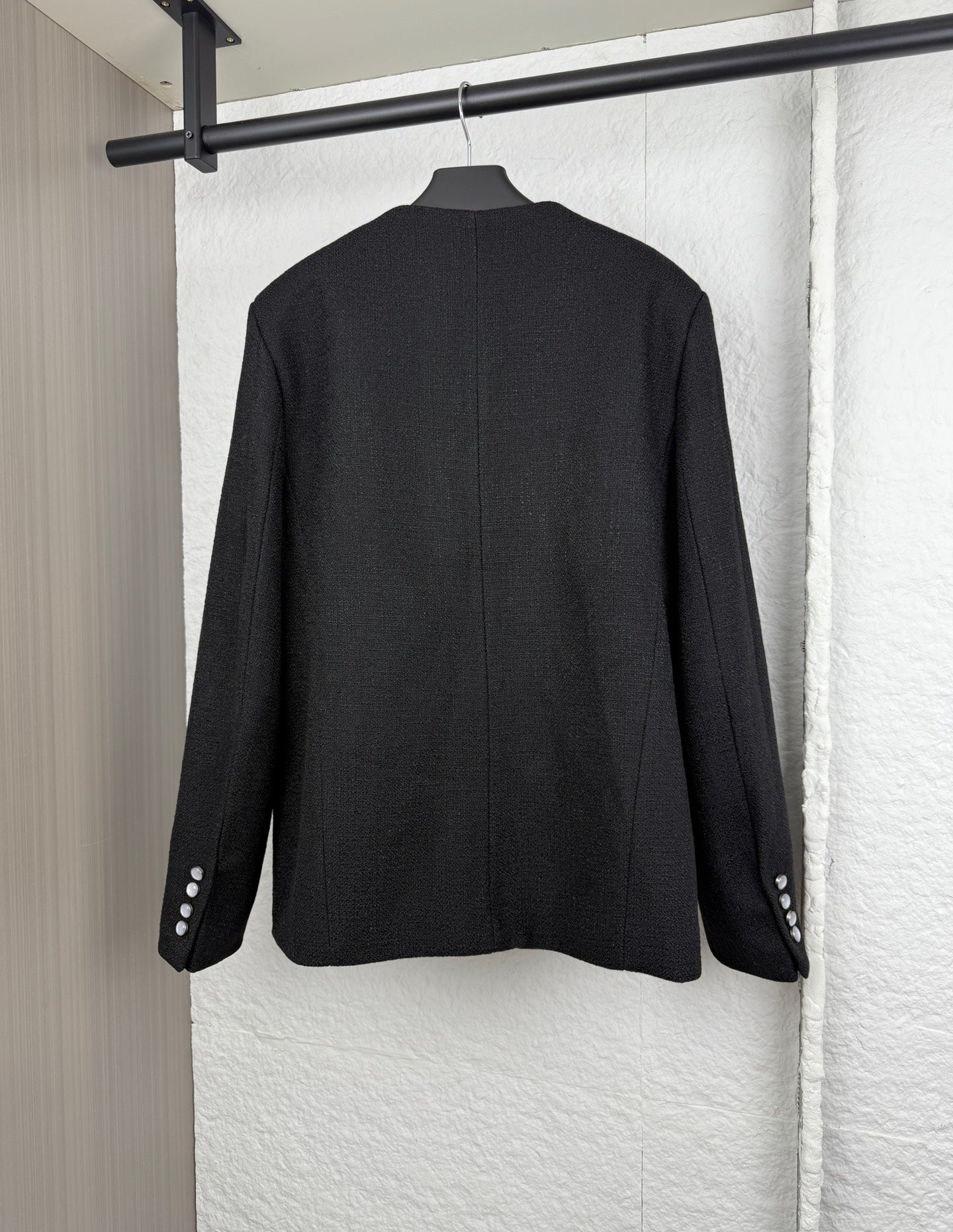 Black Louis Vuitton long jacket back view with buttoned cuffs