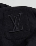 Black Louis Vuitton jacket chest detail with embossed LV monogram
