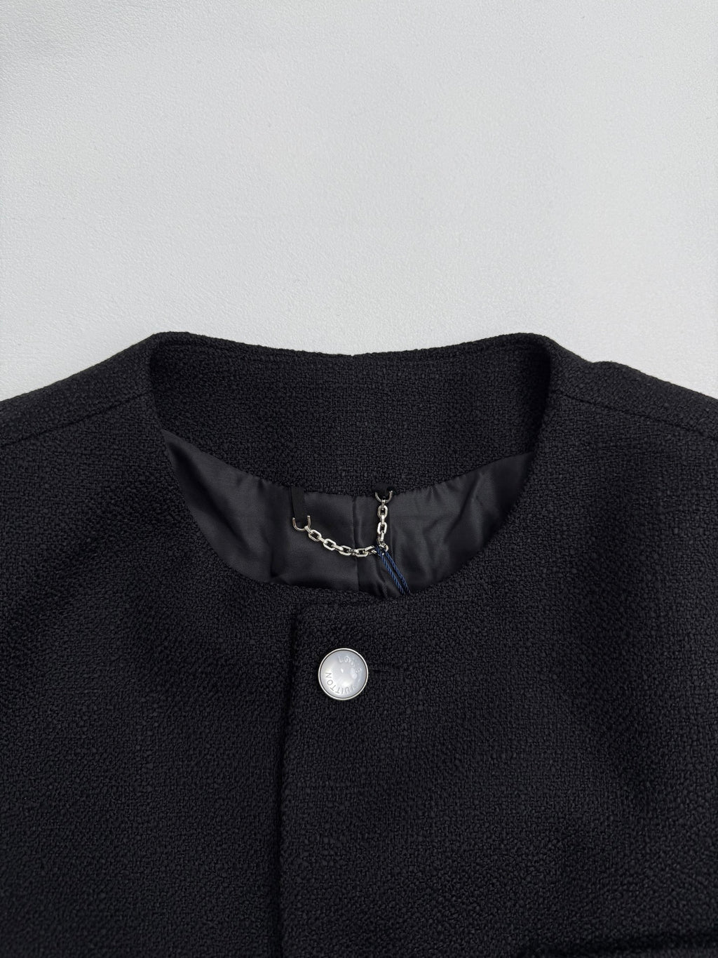 Black Louis Vuitton long jacket neckline with silver button and inner chain