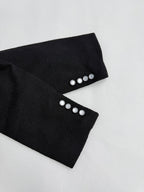Black Louis Vuitton jacket cuffs with four silver buttons each