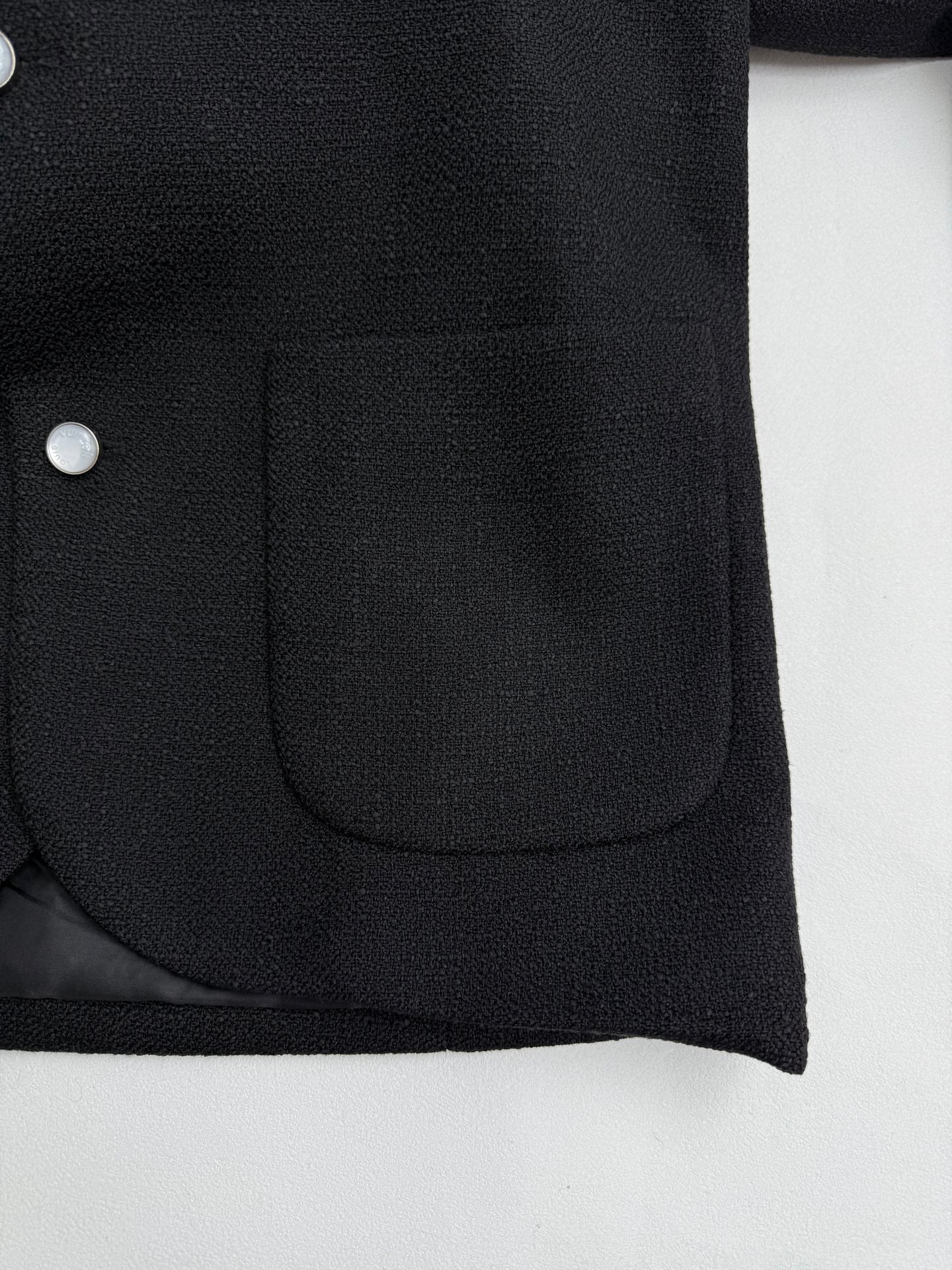 Black Louis Vuitton jacket front pocket with buttoned placket