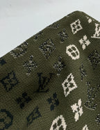 Green knit sweater knit texture with white and blue monogram motifs