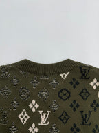 Green knit sweater upper back with monogram motifs and ribbed collar