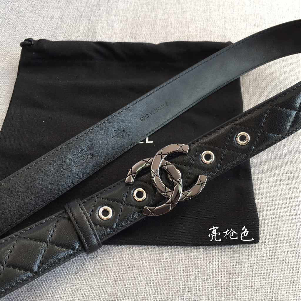 Black quilted belt with wide strap and metal interlocking buckle detail