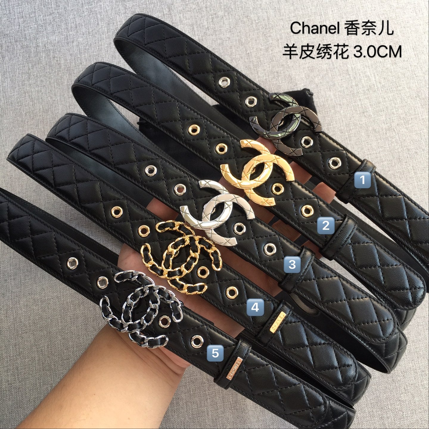 Set of black quilted Chanel-style belts with gold and silver-toned buckles and chains.