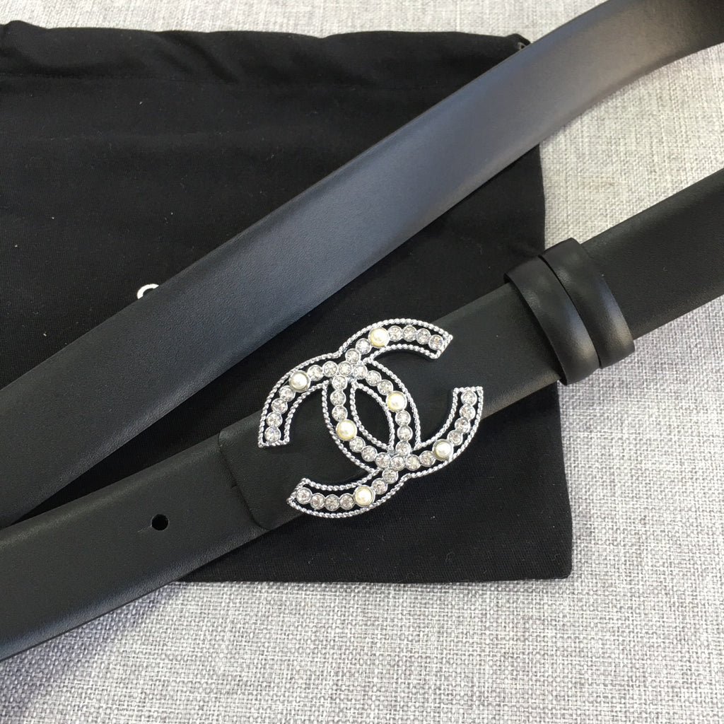 Chanel belt with rhinestone CC buckle and black strap with a wrapped keeper section.
