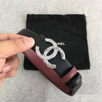 Chanel belt with black strap, burgundy center panel, and silver double-C buckle
