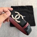 Chanel belt close-up: black strap with burgundy trim and silver double-C buckle