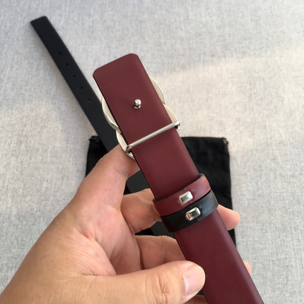 Chanel belt with burgundy leather center, black keeper, and silver buckle