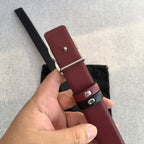 Chanel belt with burgundy leather center, black keeper, and silver buckle