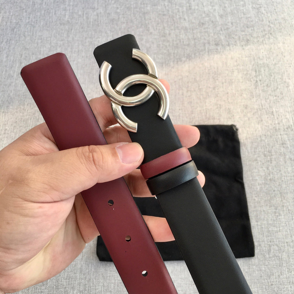 Chanel belt close-up with black strap, burgundy edge, and silver double-C buckle
