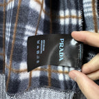 Plaid interior lining with PRADA care label on grey knit jacket