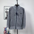 Grey textured knit full-zip jacket with mock neck and small triangle chest logo