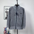 Grey textured knit full-zip jacket with mock neck and small triangle chest logo