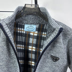 Grey knit full-zip jacket with plaid-lined interior collar and triangle chest logo