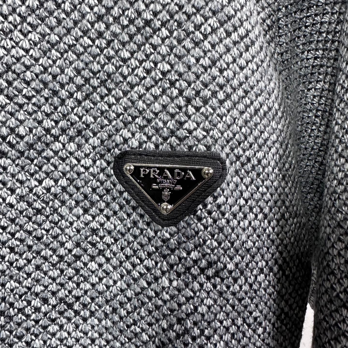 Grey textured knit jacket with black triangular PRADA logo patch