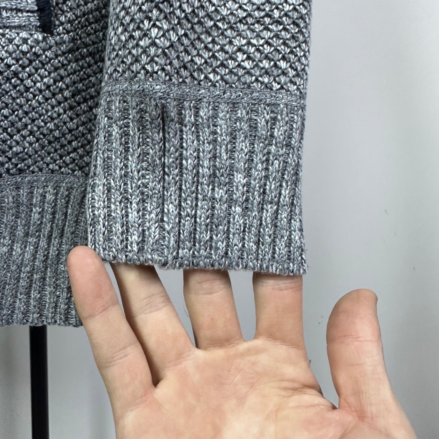 Grey knit sleeve cuff with ribbed trim