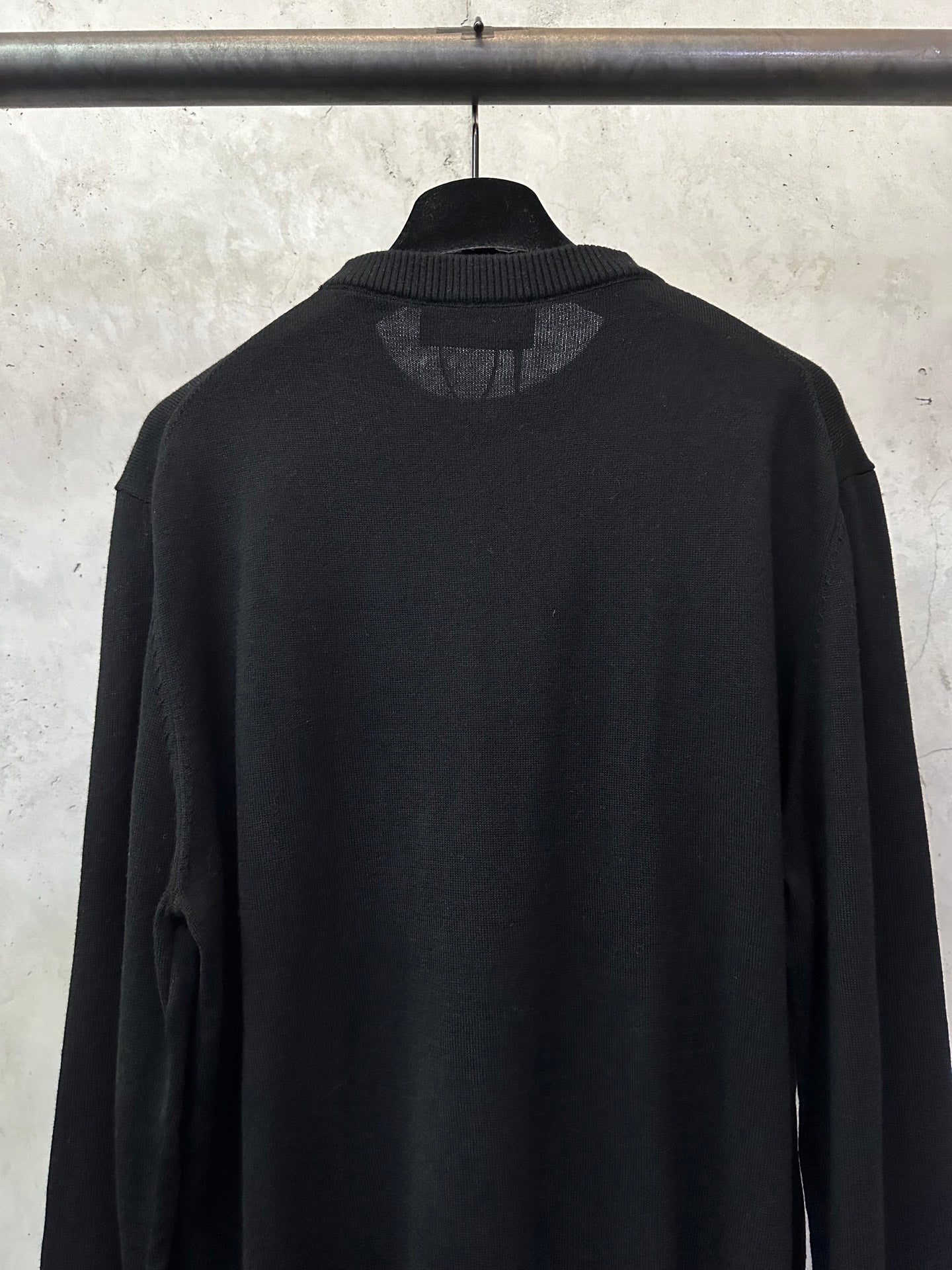 Black long-sleeve sweater with ribbed crew collar back view