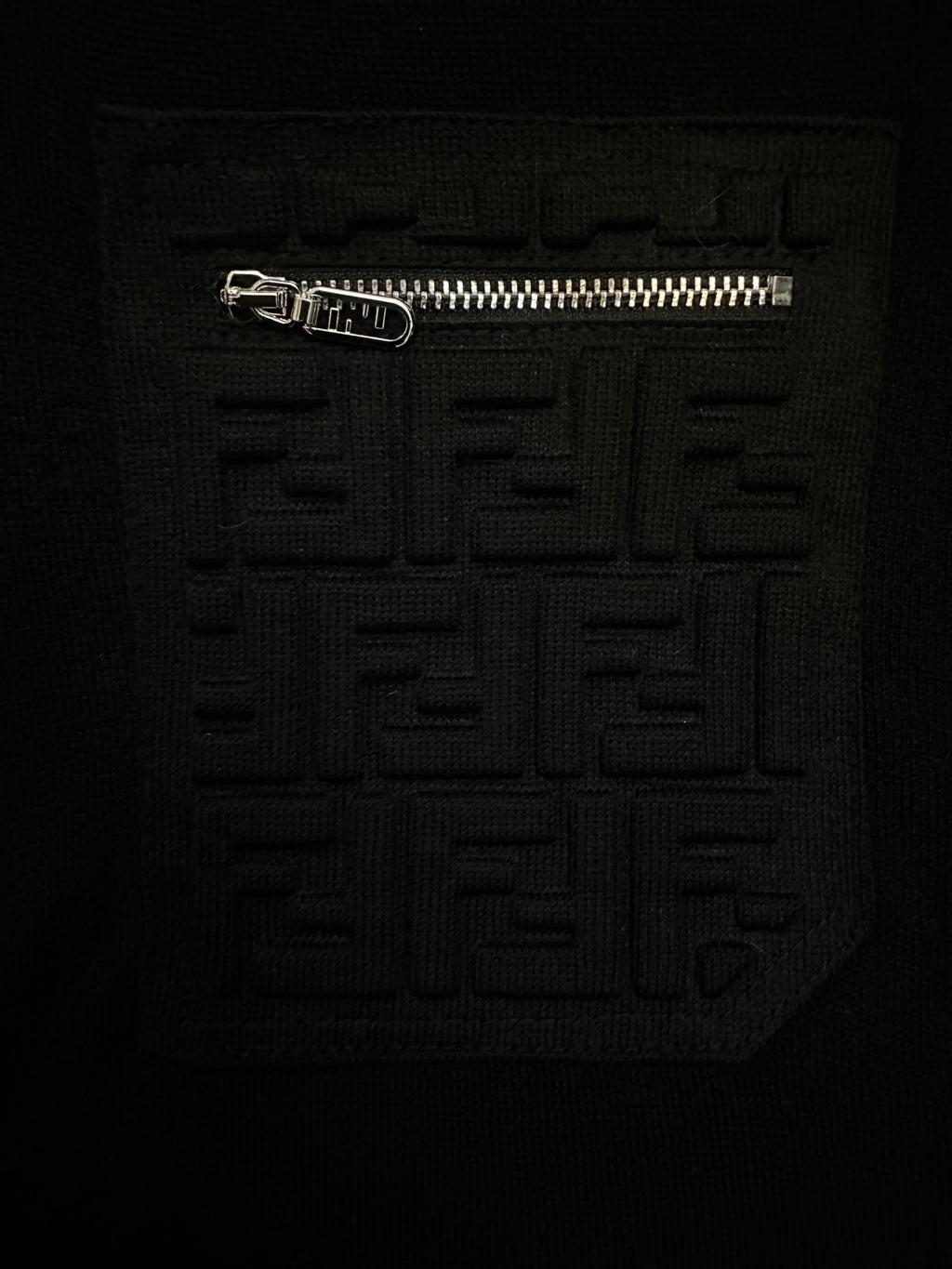 Black sweater with raised embossed Fendi logo motif on chest