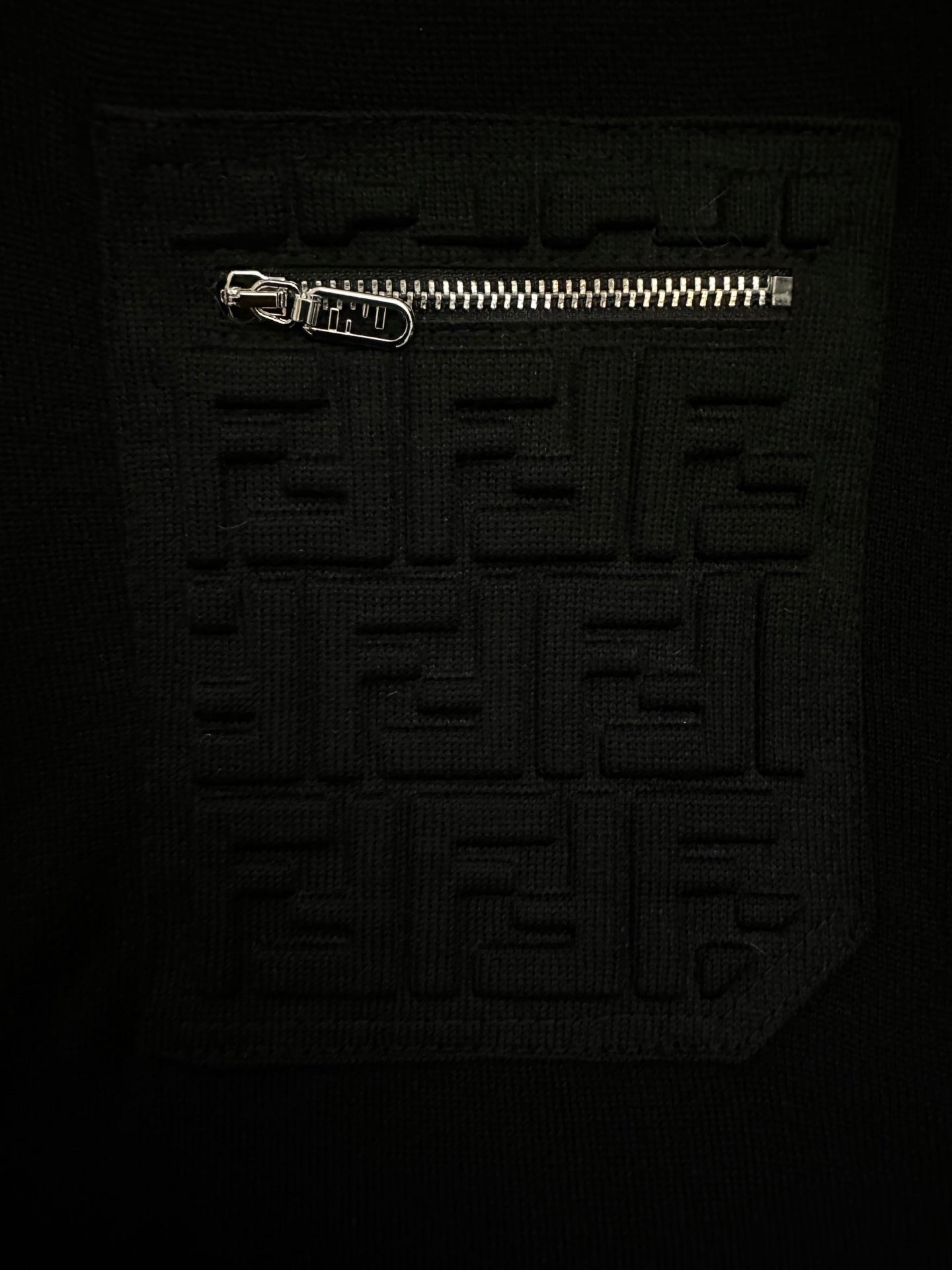 Black sweater with raised embossed Fendi logo motif on chest
