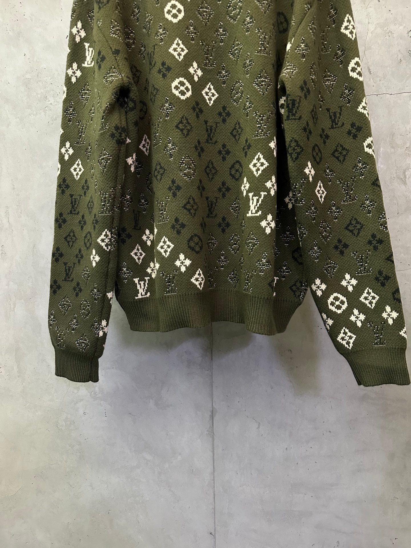 Long-sleeve sweater back, olive green knit with repeating white logo motifs