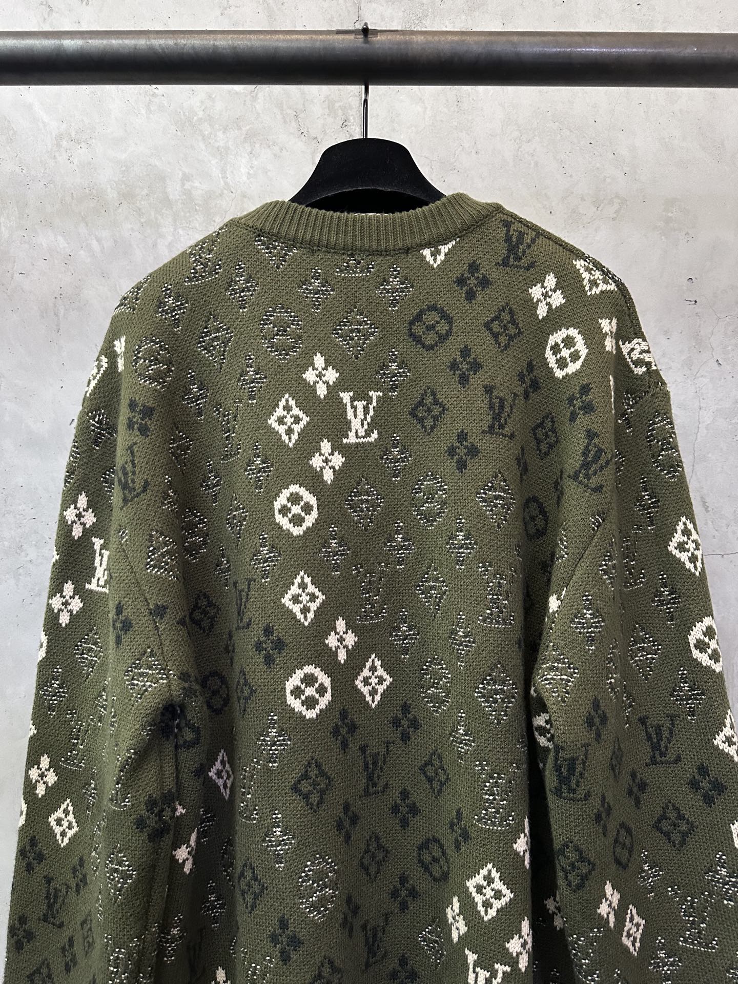 Long-sleeve sweater back view, olive green knit with white monogram pattern