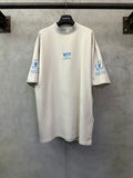 Off-white crewneck T-shirt with WFP World Food Programme logo print on chest and sleeves