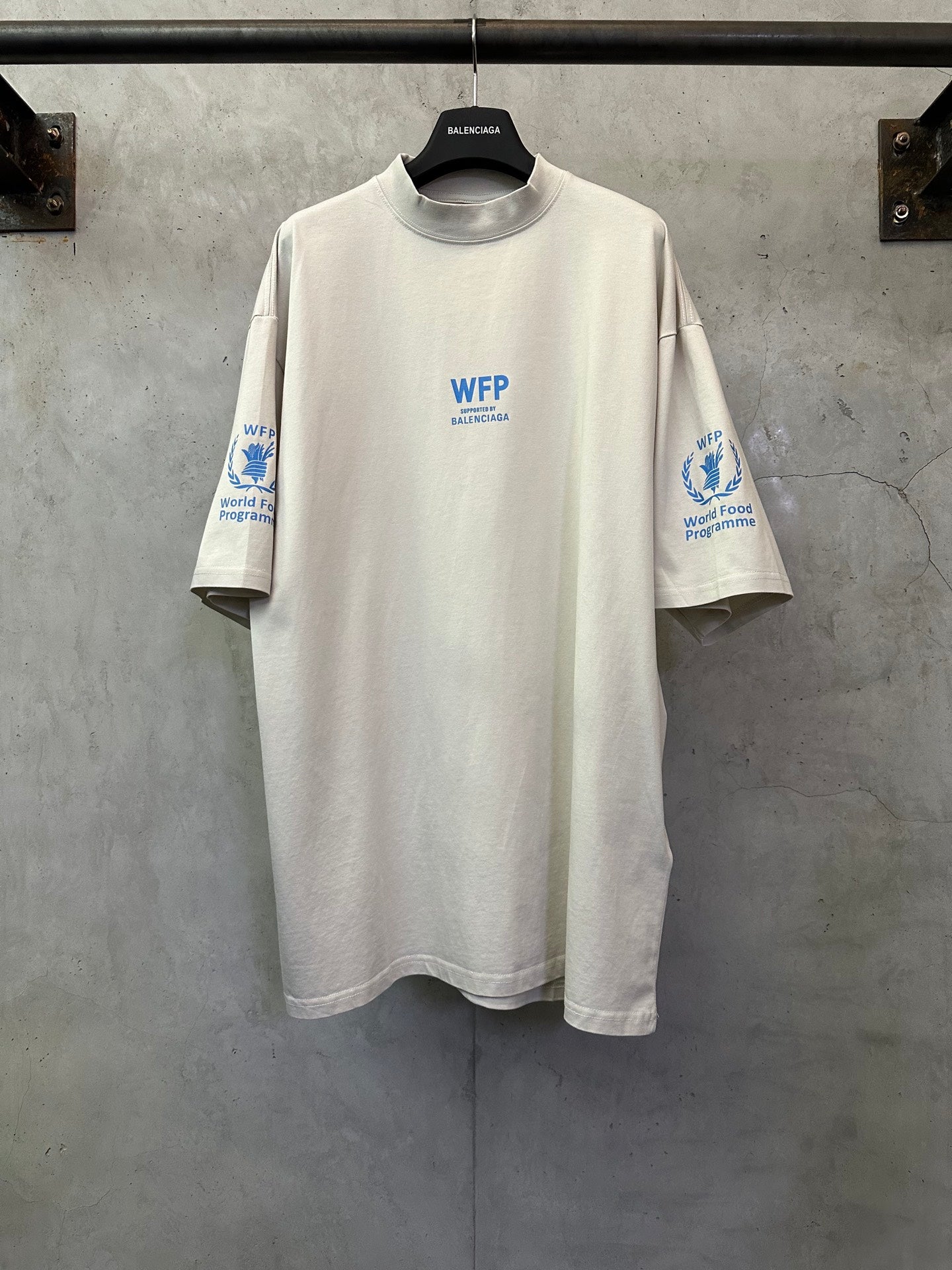 Off-white crewneck T-shirt with WFP World Food Programme logo print on chest and sleeves