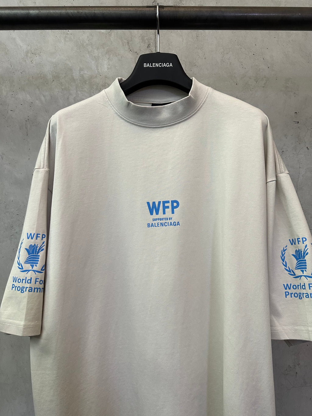 Off-white crewneck T-shirt with central blue WFP logo and World Food Programme emblem