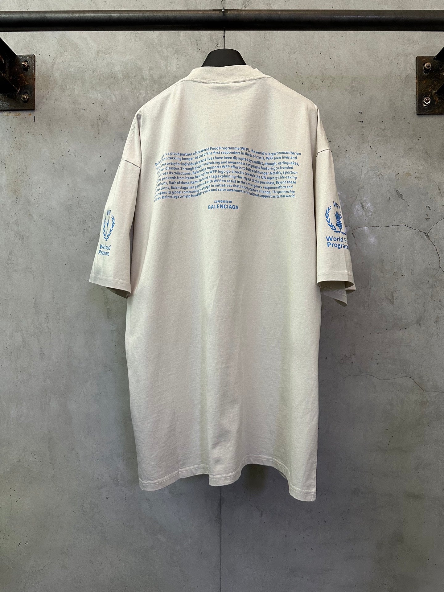 Off-white crewneck T-shirt, back view, WFP World Food Programme logo text and icons