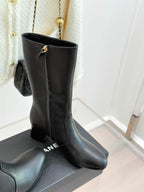 Chanel leather tall boots with gold CC hardware, standing on display box