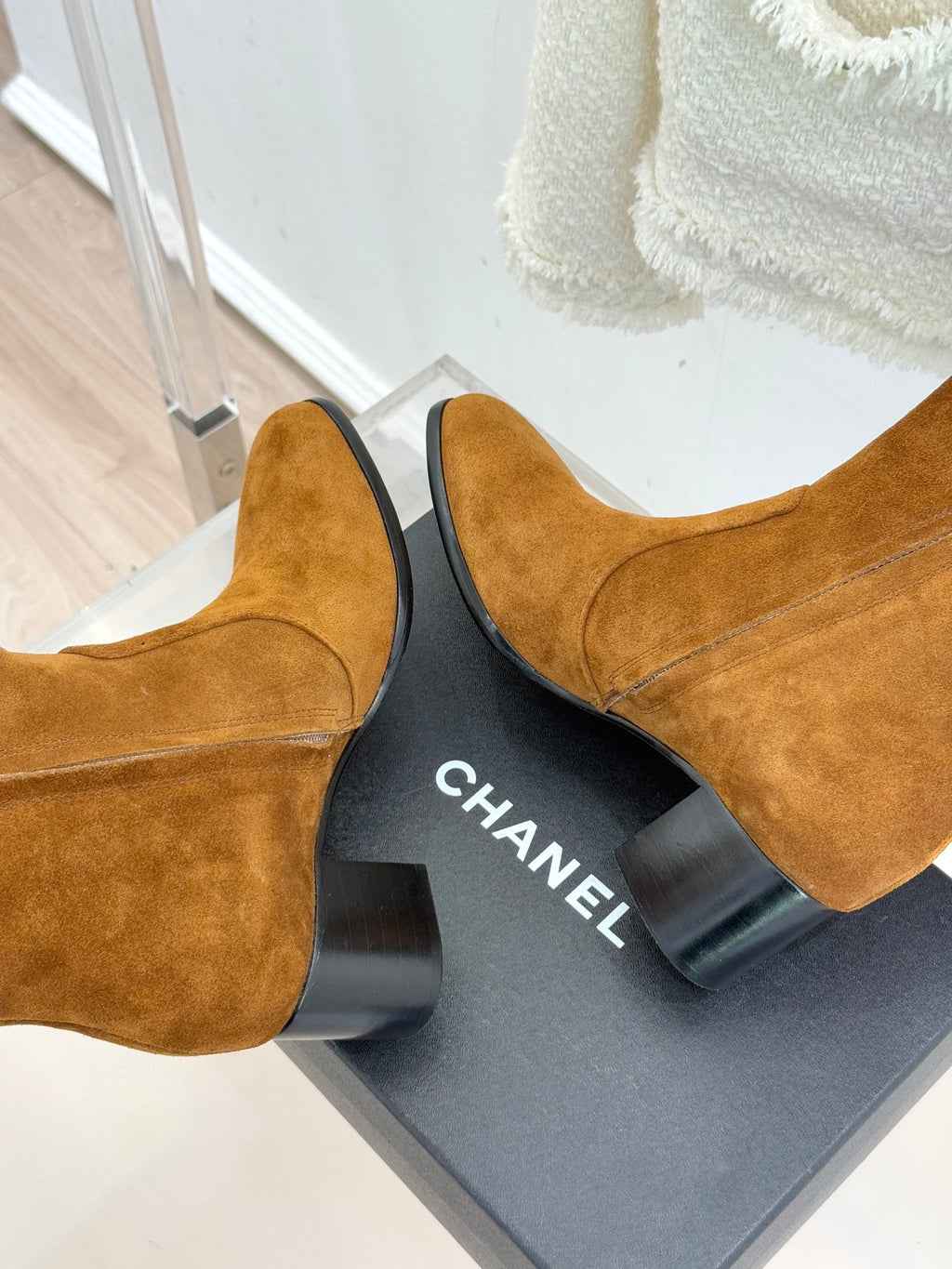 Tan suede ankle boots with CHANEL logo on the heel block