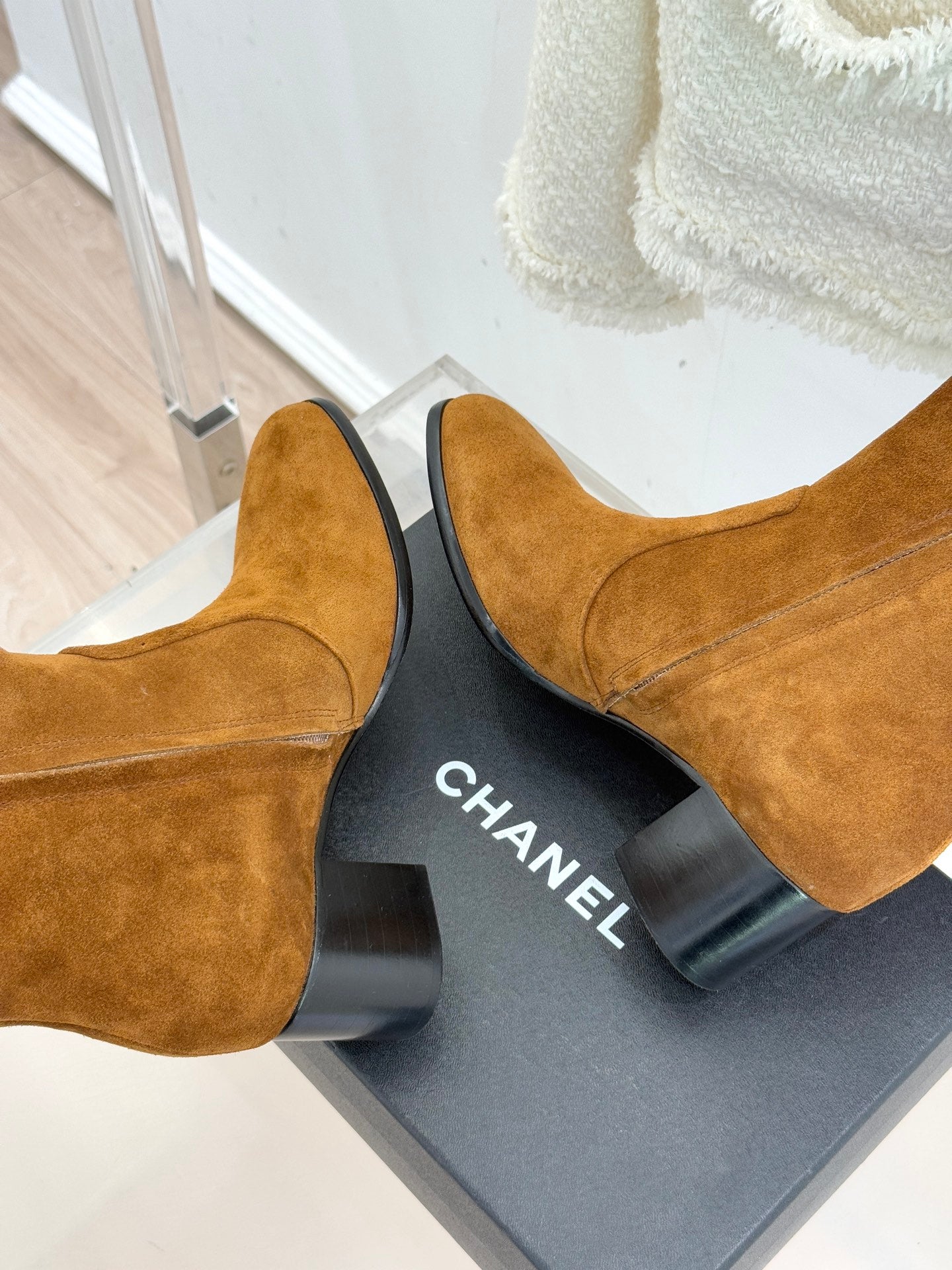 Tan suede ankle boots with CHANEL logo on the heel block