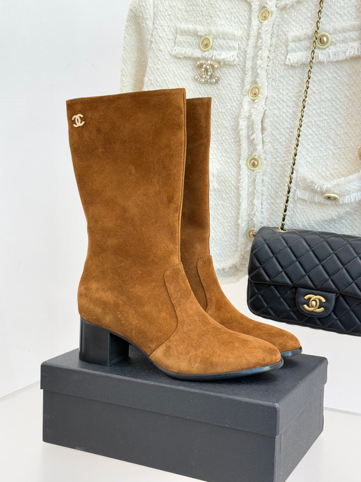 Tan suede heeled ankle boot with CC logo on side and stacked leather heel