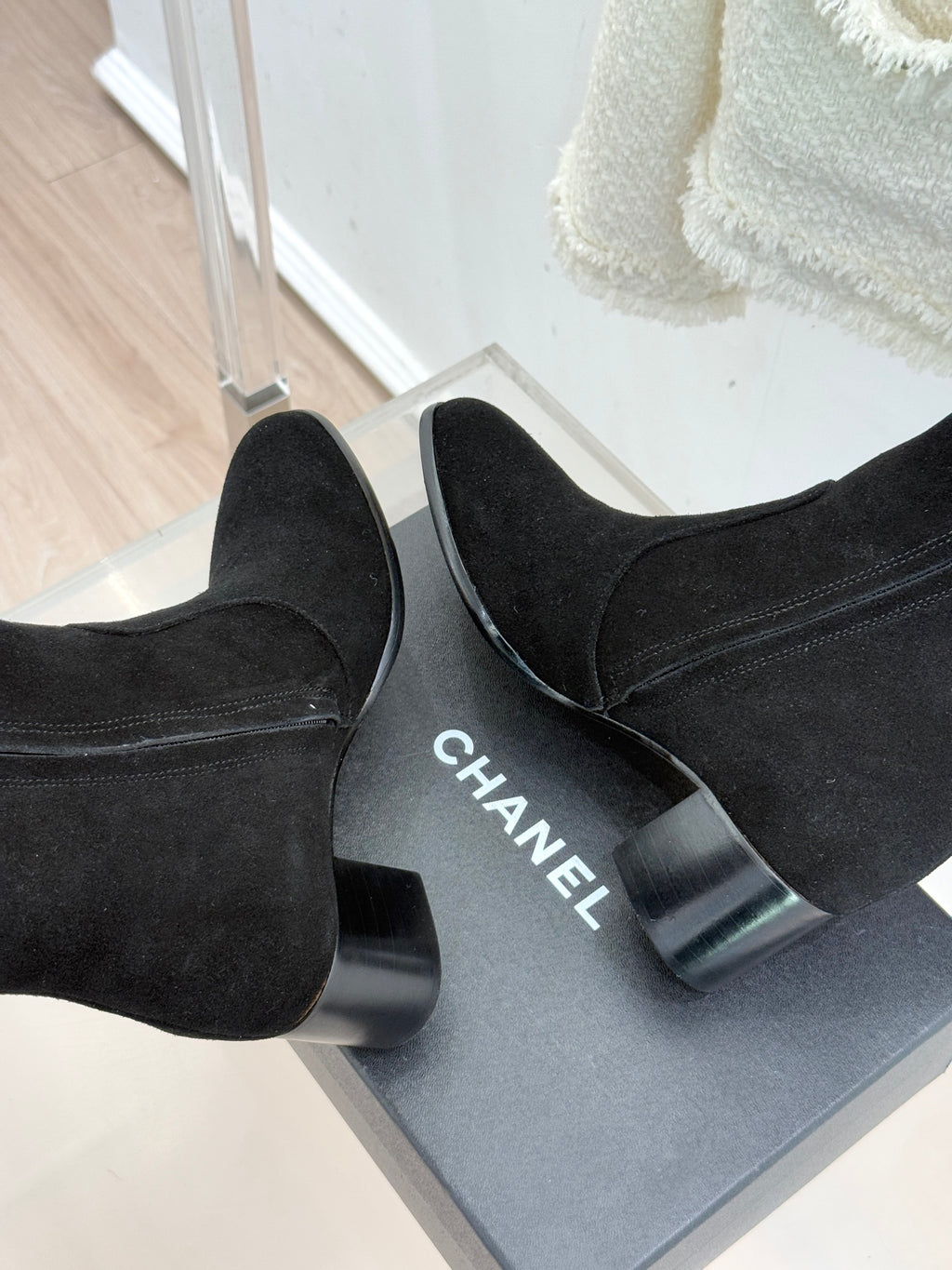 Black suede tall boots with block heels; CHANEL text visible on heel