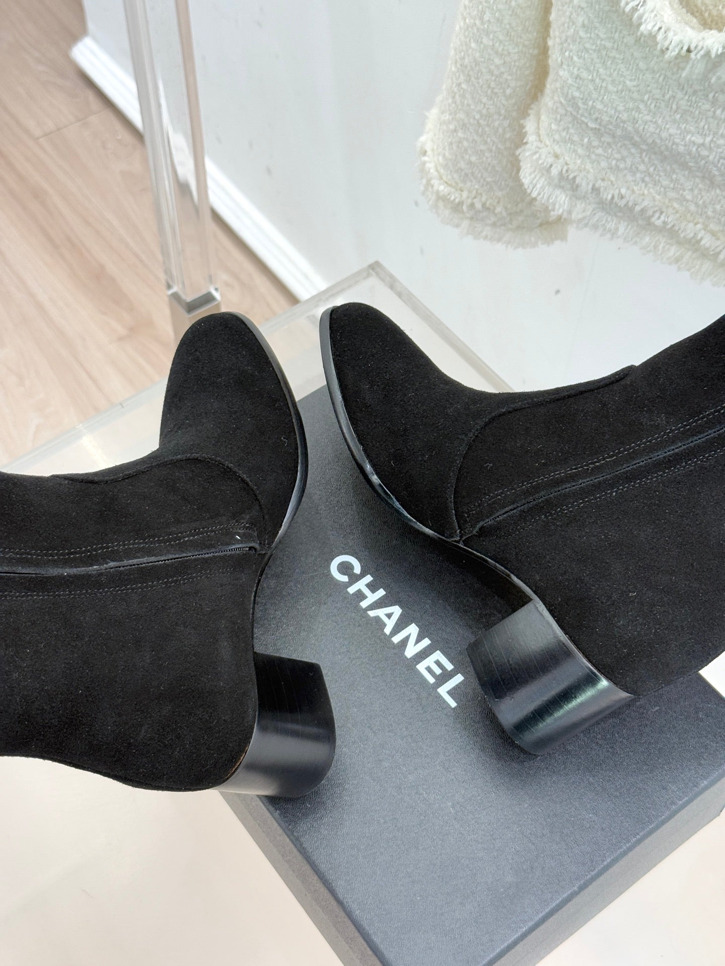 Black suede tall boots with block heels; CHANEL text visible on heel