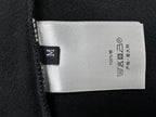 Dior care label on black sweatshirt: 100% cotton, wash and dry symbols