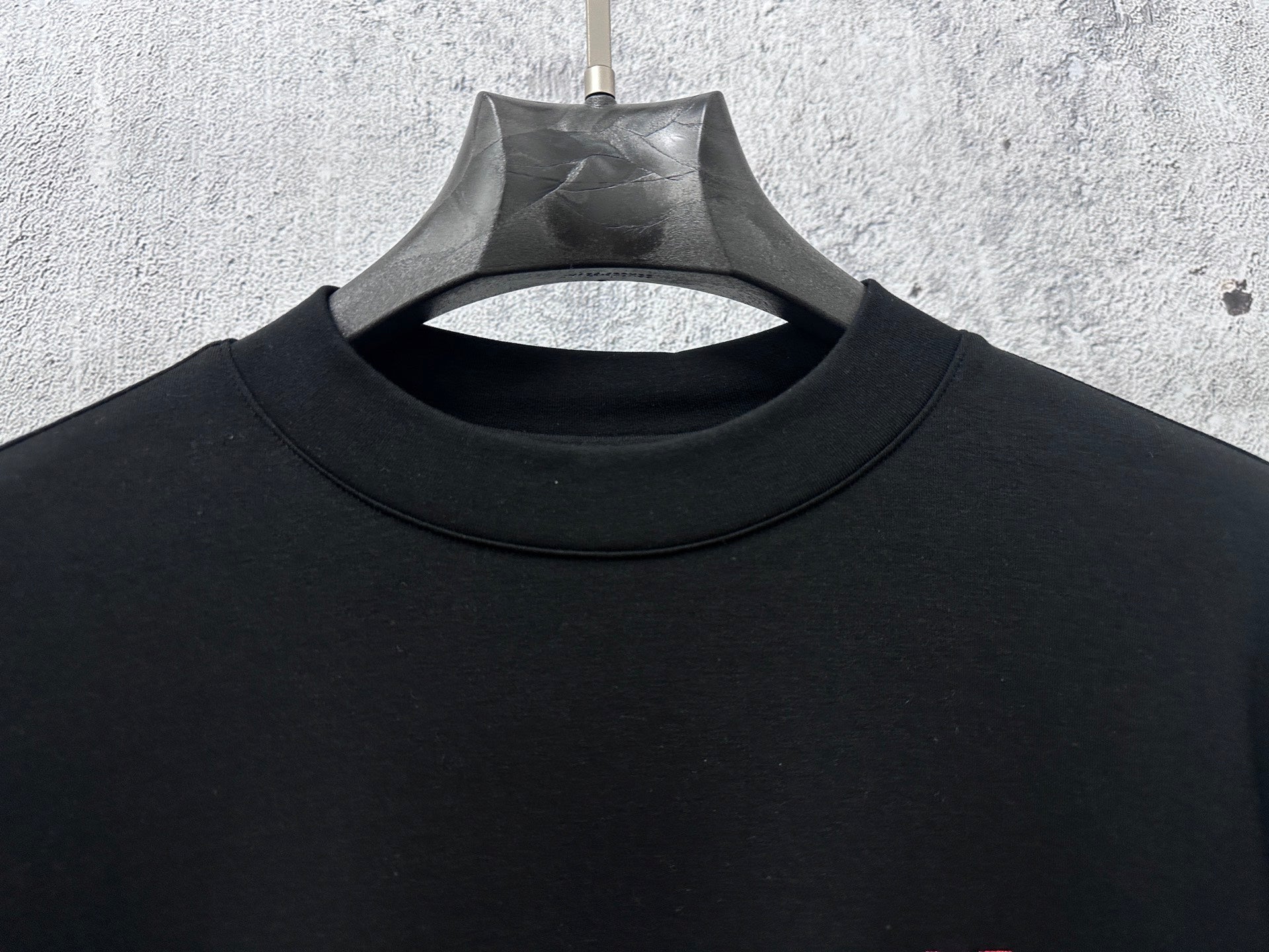 Black Dior crewneck sweatshirt neckline detail with hanging tag