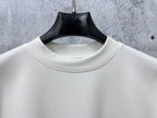 White crewneck collar on long-sleeve top with clean neckline