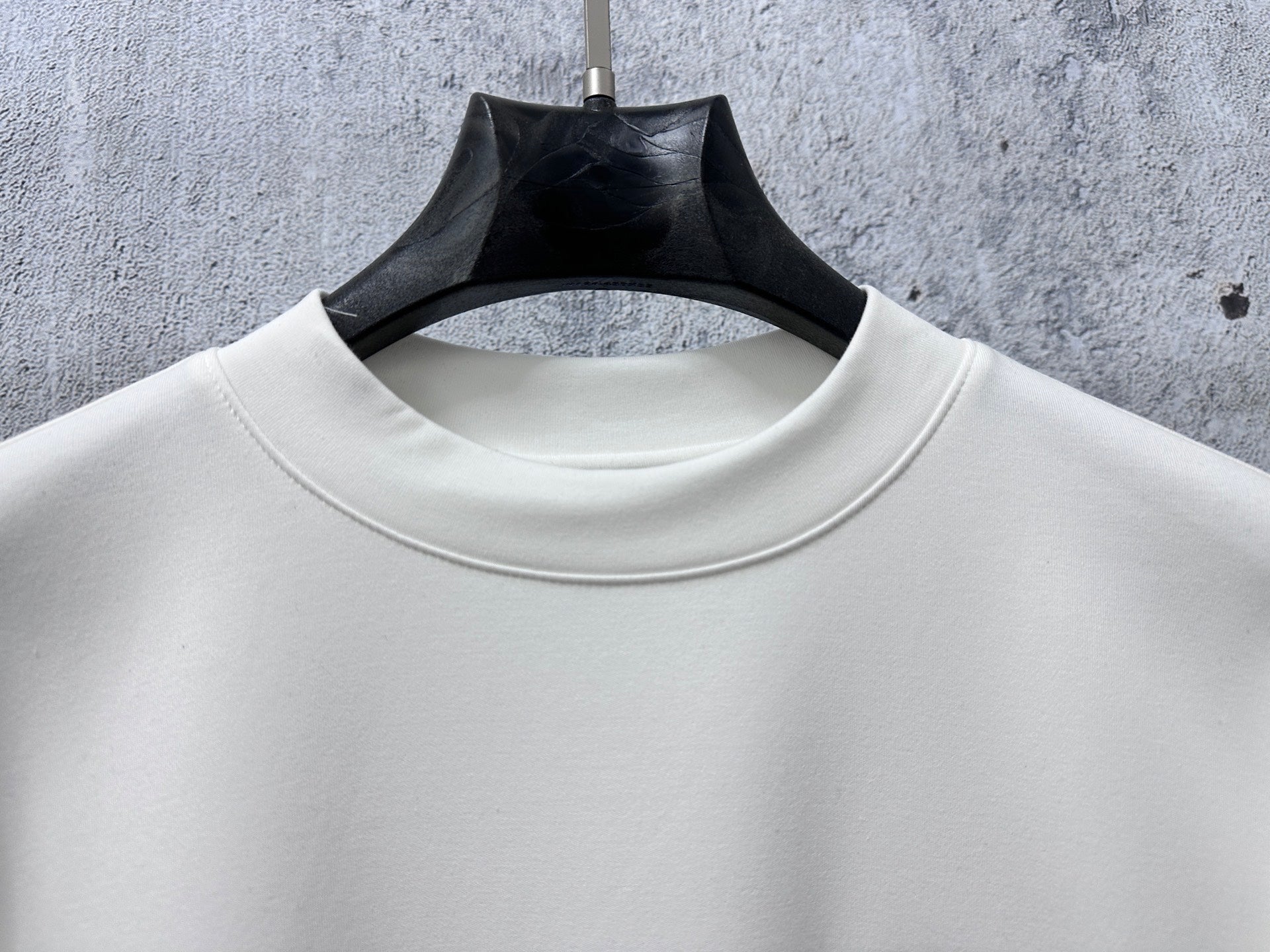 White crewneck collar on long-sleeve top with clean neckline
