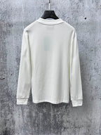 White long-sleeve crew-neck top on hanger, plain back view.