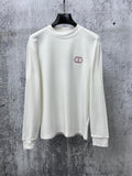 White long-sleeve crewneck top with small red-and-black CD logo on chest