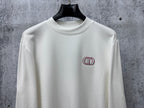 White long-sleeve top with CD logo embroidery at upper chest
