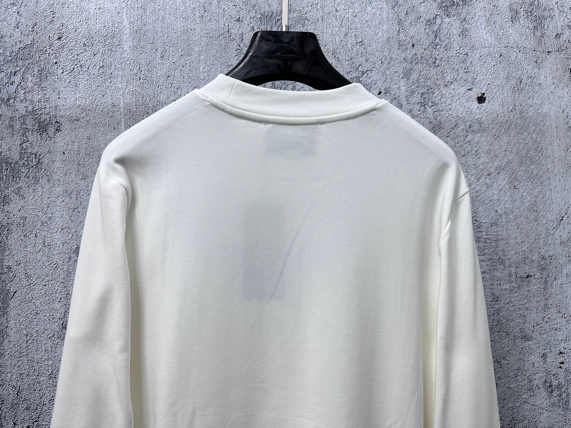 White long-sleeve crewneck top, back with smooth yoke
